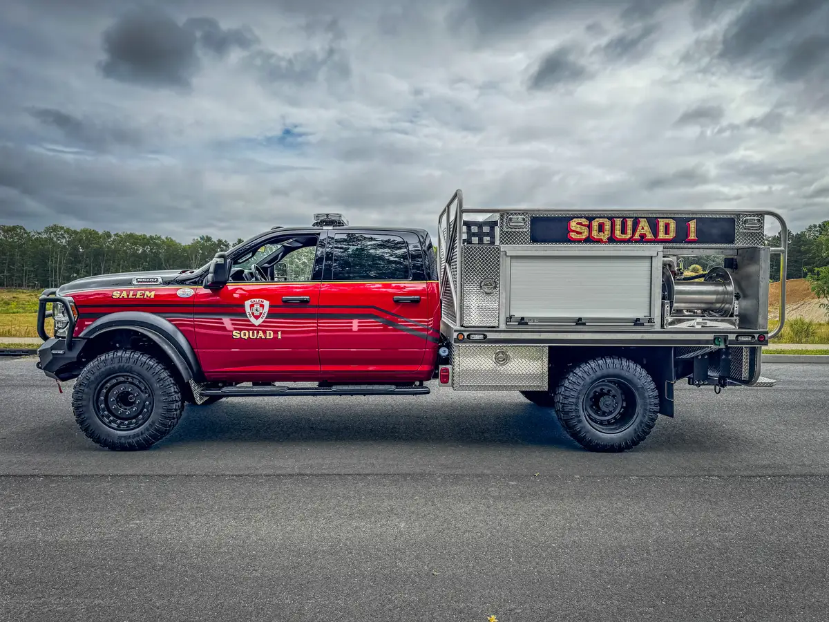 Left-side profile showing crew cab, side body, and rear compartment structure.